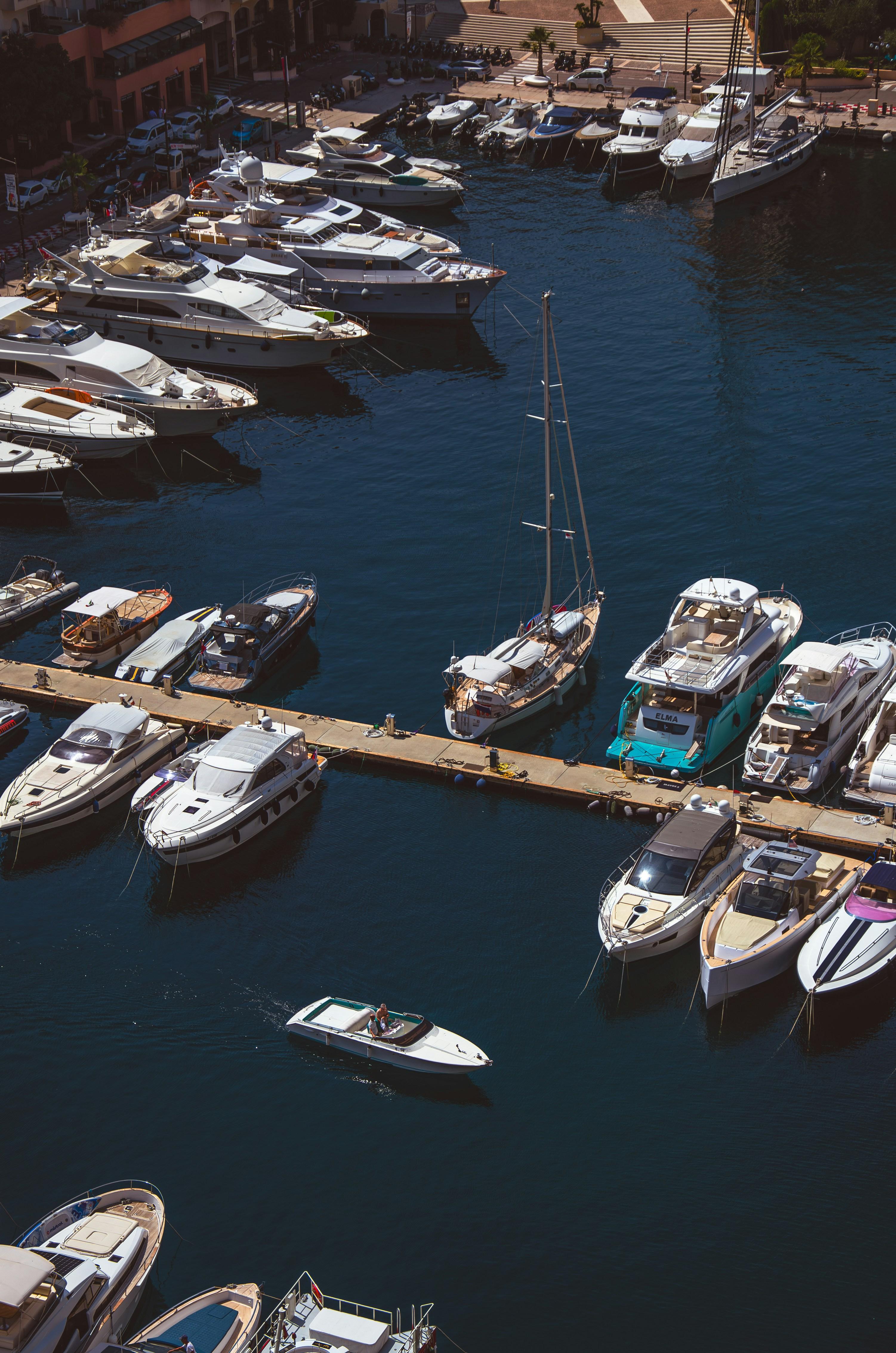 Boats and yachts docked at a sunny marina harbor