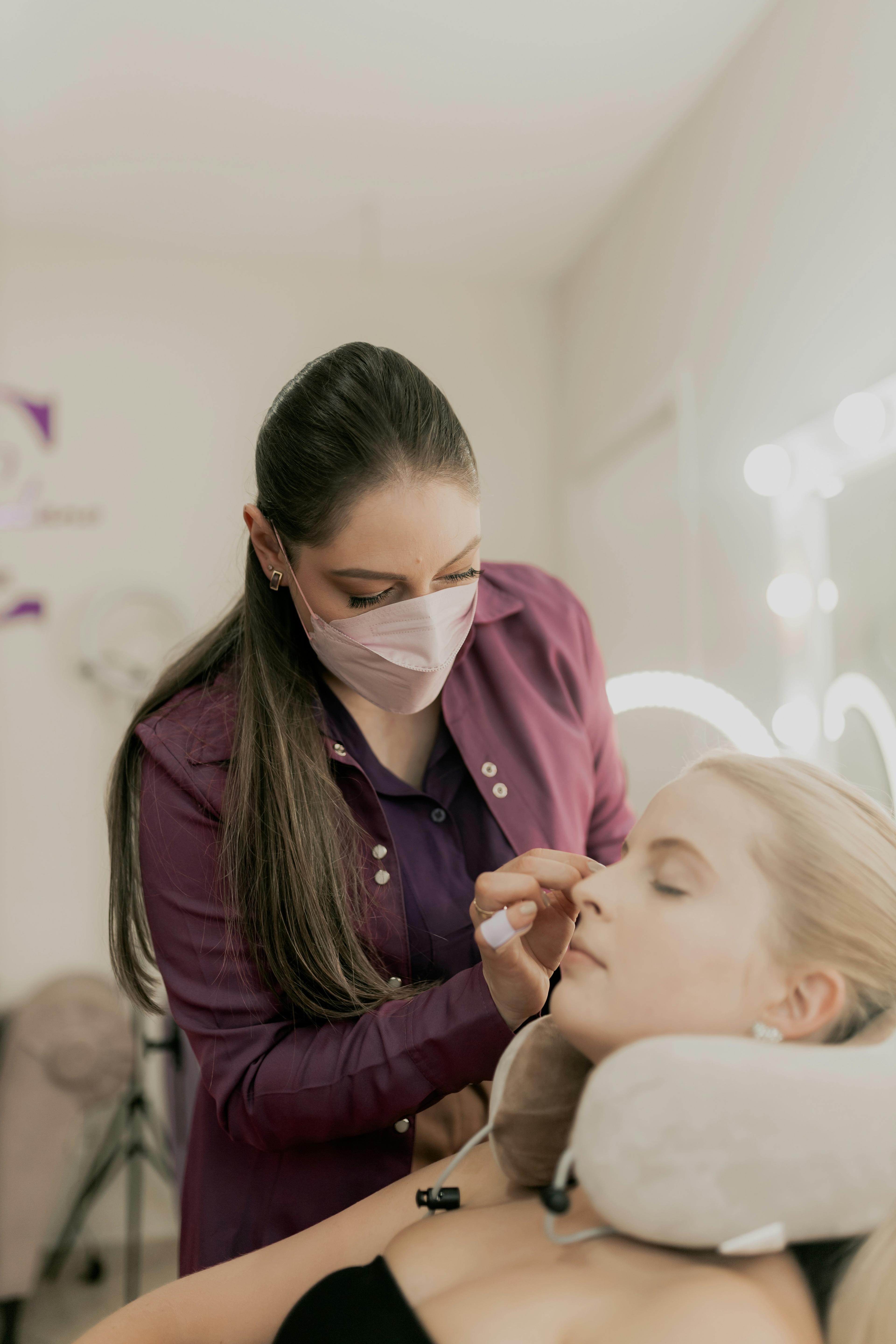 Beauty salon professional applying makeup to a client
